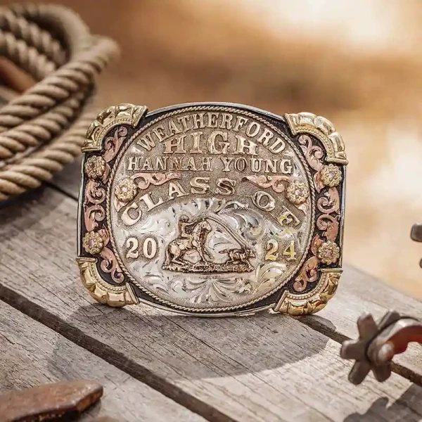 A custom class belt buckle for Weatherford High School with personalized name featuring a team roping figure 